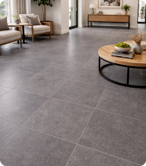 Grey stone-look flooring across a lounge with linen armchairs