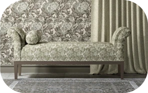 Grey damask wallpaper behind an upholstered daybed on grey flooring